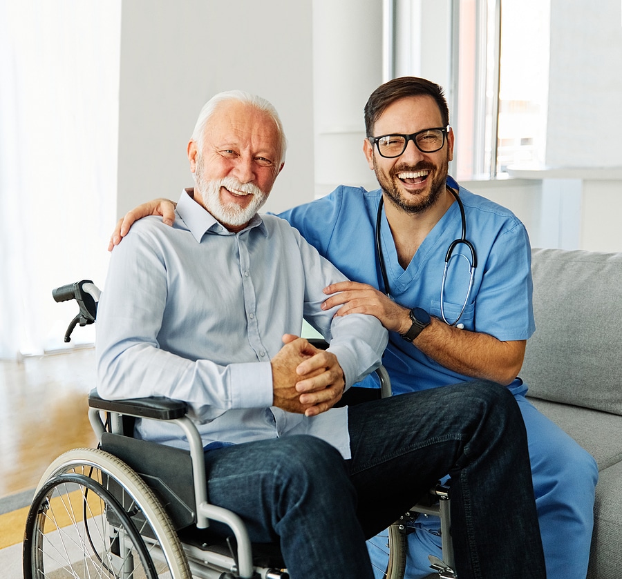 doctor or nurse caregiver helping senior man in a wheelchair at
